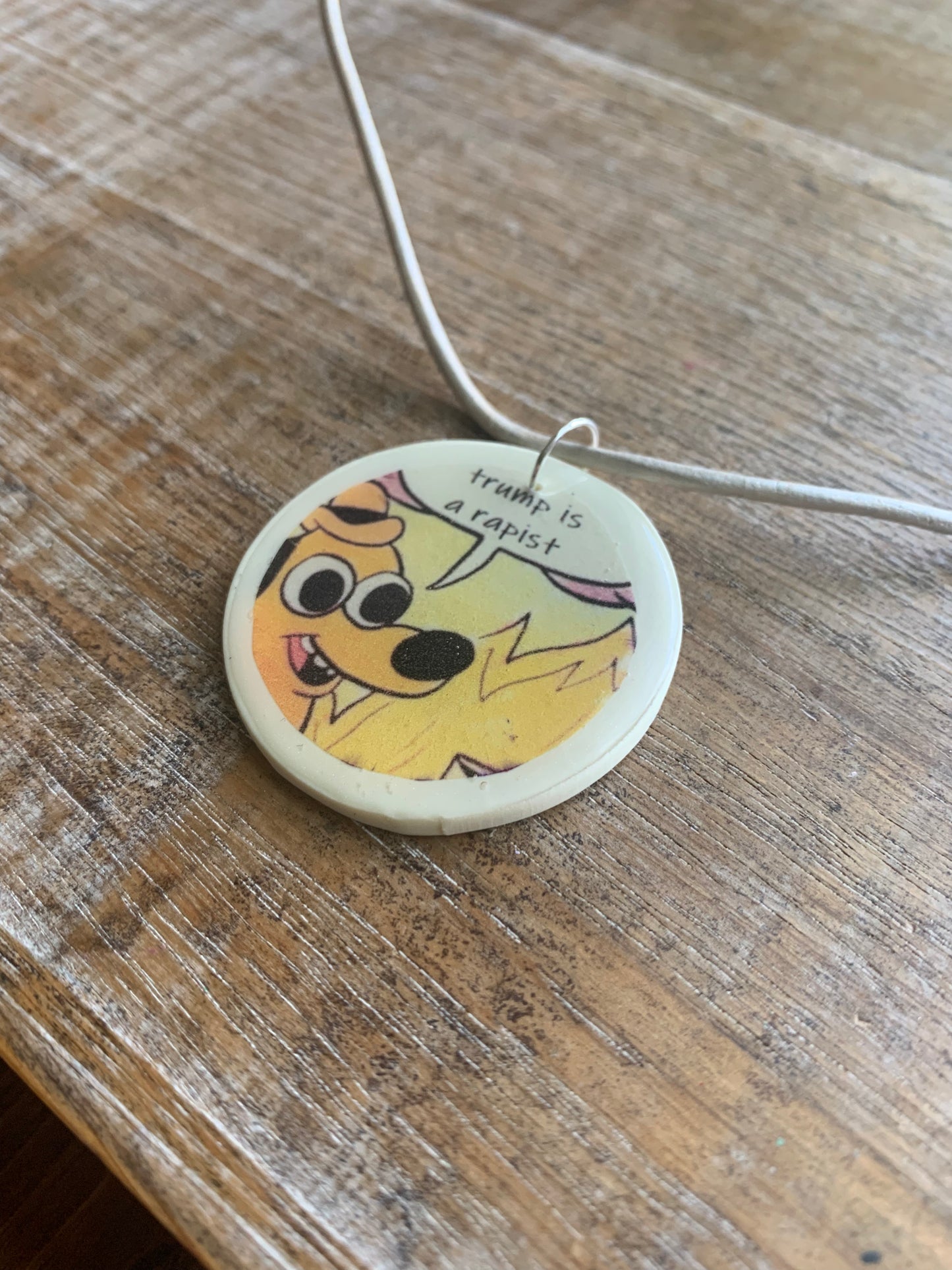 Trump Is a Rapist Fire Meme Necklace