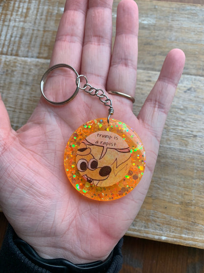 Trump is a Rapist Meme Fire Dog Keychain Orange Circle Keyring
