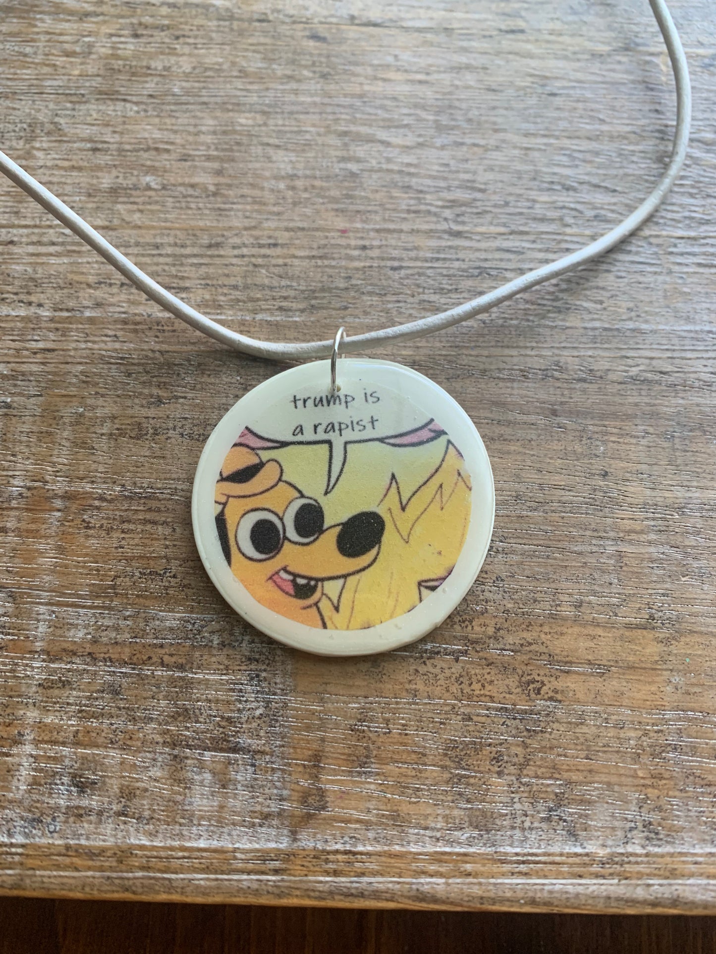 Trump Is a Rapist Fire Meme Necklace