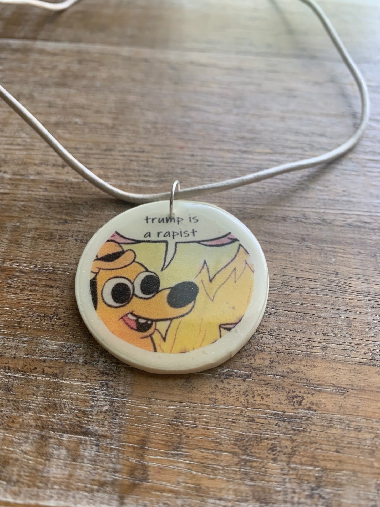 Trump Is a Rapist Fire Meme Necklace